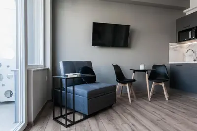 a living room with a chair and a table at WYZ Athens Apartments by UPSTREET in Athens