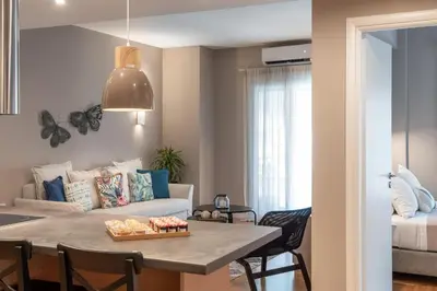 a living room with a table and a couch at Absolute Athens XII in Athens