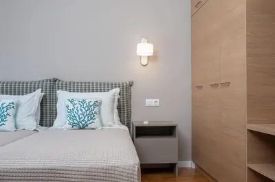 a bedroom with a bed with blue and white pillows at Absolute Athens XII in Athens