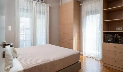 a bedroom with a bed and a large window at Absolute Athens XII in Athens