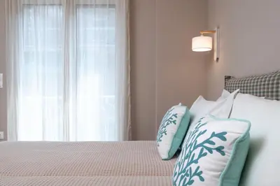 a bedroom with a bed with blue and white pillows at Absolute Athens XII in Athens
