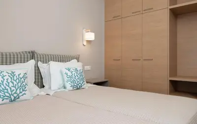 a bedroom with a bed with white and blue pillows at Absolute Athens XII in Athens
