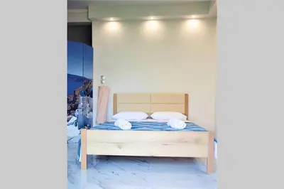 a bedroom with a bed with blue sheets and white pillows at Athens Central 3BD Apartment next to Metro Luxury in Athens