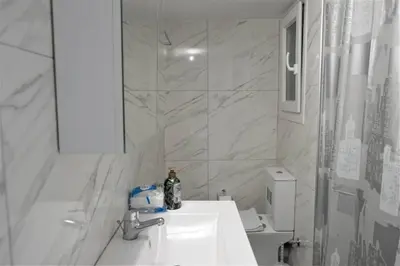 a white bathroom with a sink and a shower at Athens Central 3BD Apartment next to Metro Luxury in Athens