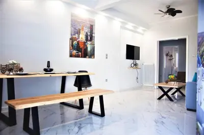 a living room with a table and a tv at Athens Central 3BD Apartment next to Metro Luxury in Athens