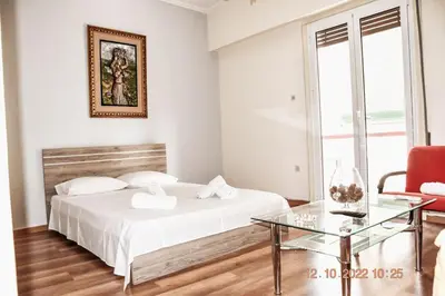 a white bedroom with a bed and a glass table at Athens Central 3BD Apartment next to Metro Luxury in Athens