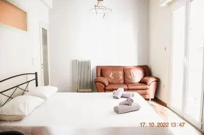 a bedroom with a bed and a leather chair at Athens Central 3BD Apartment next to Metro Luxury in Athens
