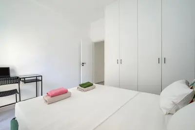a white bedroom with white cabinets and a bed at Majestic Flat with Huge Terrace in the City Center in Athens