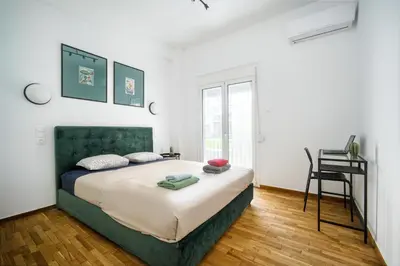 a bedroom with a bed and a desk in it at Majestic Flat with Huge Terrace in the City Center in Athens