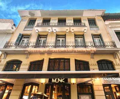 a large white building with a mux sign on it at MONK Monastiraki Suites in Athens