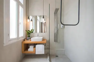 a bathroom with a sink and a shower at MONK Monastiraki Suites in Athens