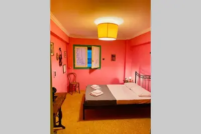 a bedroom with red walls and a bed in a room at Villa Kunterbunt in Athens