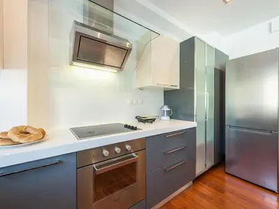 a kitchen with a stove and a refrigerator at Welcome to Lumen Villa the first of the Adelos Trilogy in Athens