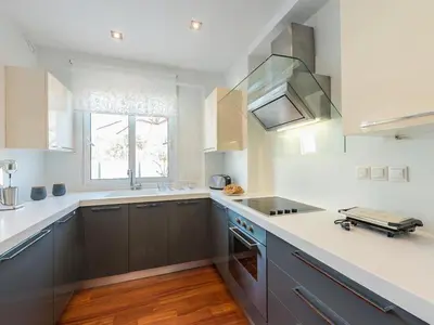 a kitchen with gray cabinets and a sink and a window at Welcome to Lumen Villa the first of the Adelos Trilogy in Athens