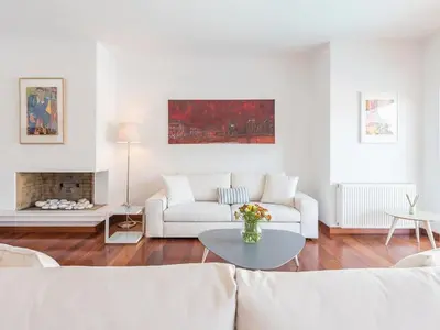 a white living room with a white couch and a table at Welcome to Lumen Villa the first of the Adelos Trilogy in Athens