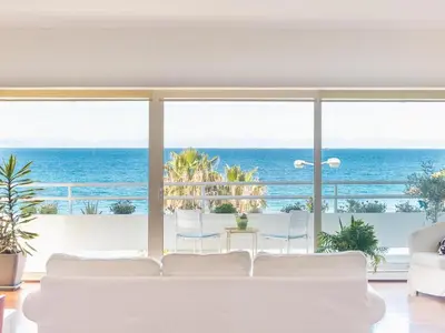 a living room with a white couch and a view of the ocean at Adelos Coastal Chic by the Sea - Athens Riviera in Athens