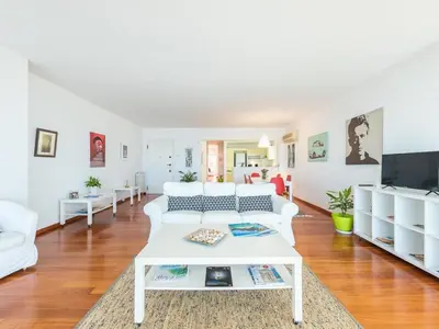 a living room with a white couch and a table at Adelos Coastal Chic by the Sea - Athens Riviera in Athens