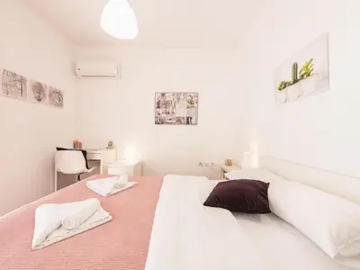 a white bedroom with a large bed with two white towels at Adelos Coastal Chic by the Sea - Athens Riviera in Athens