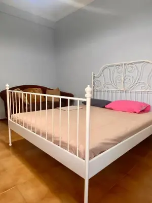 a bedroom with a white bed in a room at Tiffany's 5' min from airport in Spáta