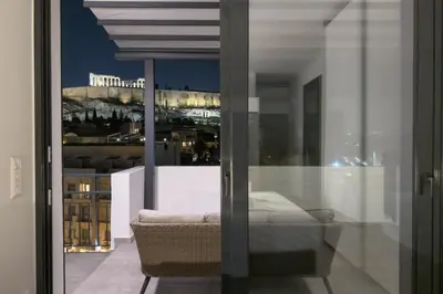 a view of the city from the balcony of a building at Cozy Deck Roof Apt at the Foothills of Acropolis in Athens