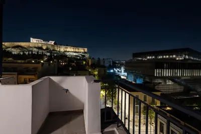 a view of the city at night at Cozy Deck Roof Apt at the Foothills of Acropolis in Athens