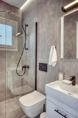 a bathroom with a shower and a toilet and a sink at Cozy Deck Roof Apt at the Foothills of Acropolis in Athens