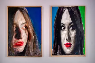 two paintings of a woman on a wall at Cozy Deck Roof Apt at the Foothills of Acropolis in Athens