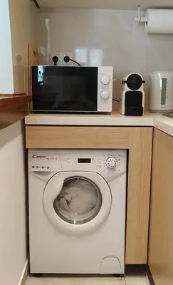 a microwave sitting on top of a washing machine at Studio Agia Marina Koropi in Aghia Marina