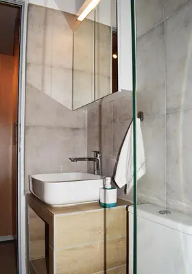 a bathroom with a sink and a tub at Studio Agia Marina Koropi in Aghia Marina