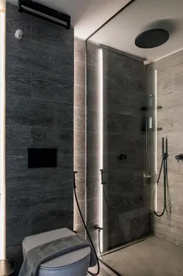 a bathroom with a toilet and a glass shower at Kavouri Seaside Luxury Bungalow in Athens