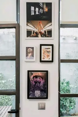 a wall with pictures on a wall with windows at Fashionable Base in Central Athens in the Old Tailor Factory in Athens
