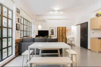 a living room with a couch and a table at Fashionable Base in Central Athens in the Old Tailor Factory in Athens