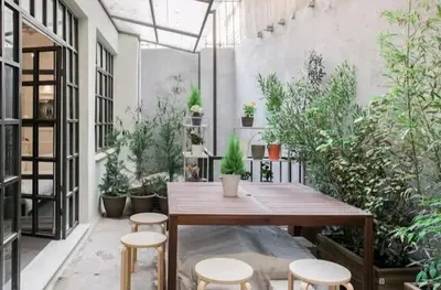 a room with a table and chairs and plants at Fashionable Base in Central Athens in the Old Tailor Factory in Athens