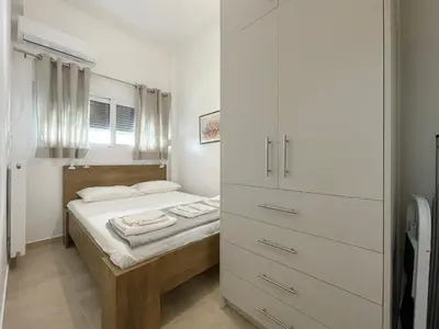a small bedroom with a bed and a closet at SOKOS Residence, 4' walk from Syngrou-Fix Metro in Athens