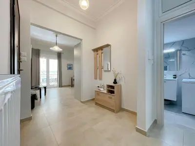 a large bathroom with a sink and a mirror at SOKOS Residence, 4' walk from Syngrou-Fix Metro in Athens