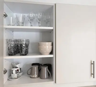 a cupboard with wine glasses and other kitchen items at SOKOS Residence, 4' walk from Syngrou-Fix Metro in Athens