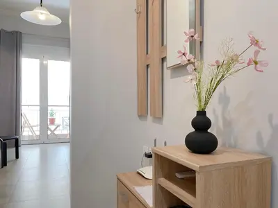 a vase with flowers on a table in a room at SOKOS Residence, 4' walk from Syngrou-Fix Metro in Athens