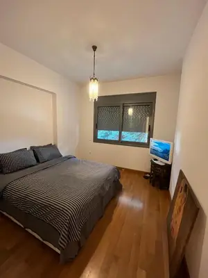 a bedroom with a bed and a television in it at Ultra-Modern Living, Luxe 4BR with Private Outdoor Pool in Athens