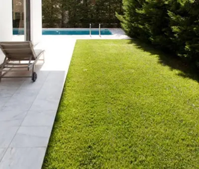 a lawn with a bench next to a pool at Ultra-Modern Living, Luxe 4BR with Private Outdoor Pool in Athens