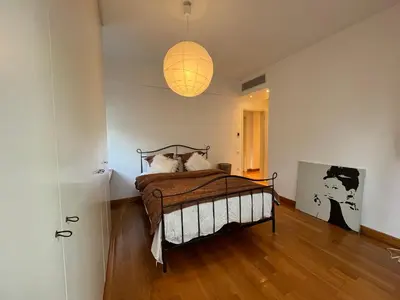 a bedroom with a bed and a lamp at Ultra-Modern Living, Luxe 4BR with Private Outdoor Pool in Athens