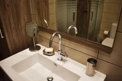 a bathroom with a white sink and a mirror at Skip Away from the Acropolis Museum by Athenian Homes in Athens
