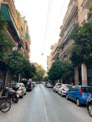 a street with cars parked on the side of the road at Skip Away from the Acropolis Museum by Athenian Homes in Athens