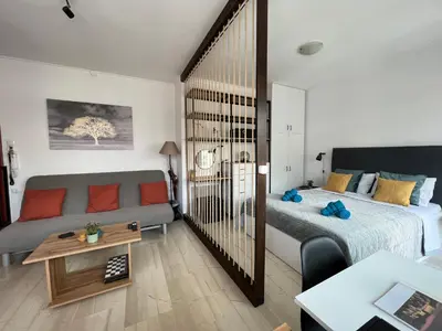 a living room with a bed and a couch at Athena Βright & New Studio - 25' walk to the Acropolis in Athens