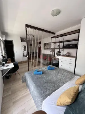 a bedroom with a large bed and a desk at Athena Βright & New Studio - 25' walk to the Acropolis in Athens