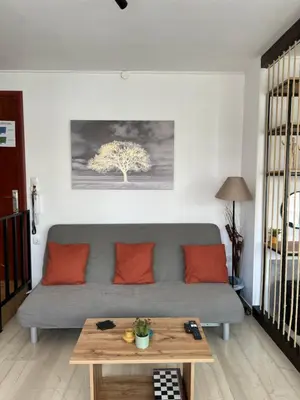 a living room with a couch and a table at Athena Βright & New Studio - 25' walk to the Acropolis in Athens