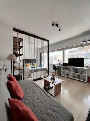 a bedroom with a bed and a television in it at Athena Βright & New Studio - 25' walk to the Acropolis in Athens