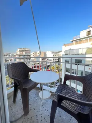 a patio with two chairs and a table on a balcony at Hermes New & Comfy Studio - 25' walk to the Acropolis in Athens