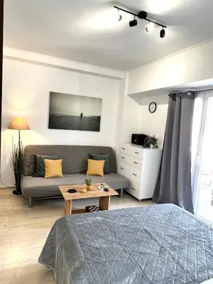 a living room with a bed and a couch at Hermes New & Comfy Studio - 25' walk to the Acropolis in Athens