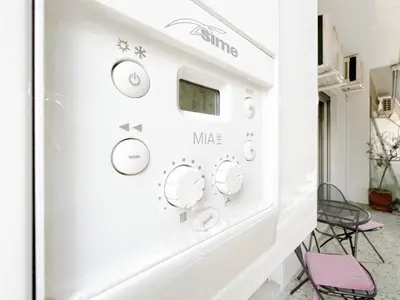 a wall with clocks on it in a room at SOKOS Residence, 5' walk from Acropolis Museum in Athens