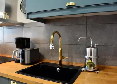a kitchen sink with a faucet on a counter at Erato by Heloni Apartments in Athens